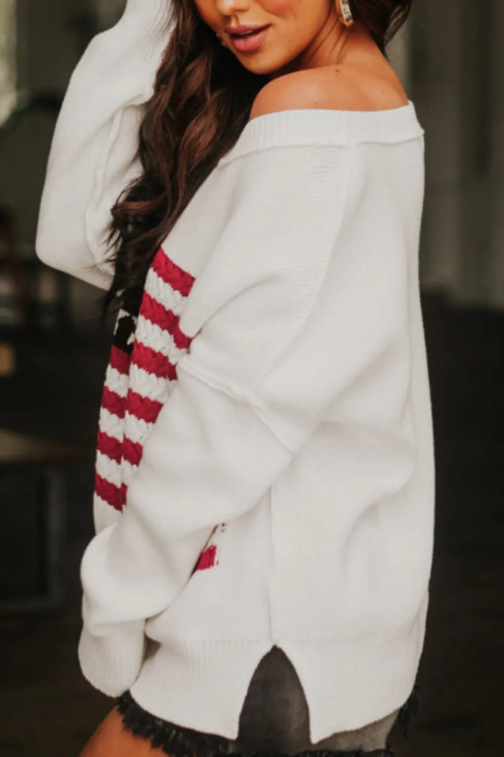 Acrylic cotton blend sweater with US flag design and side slits, featuring drop shoulders.