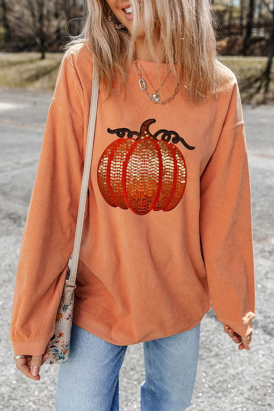 Long sleeve round neck sweatshirt with a pumpkin sequin design and cozy fit.