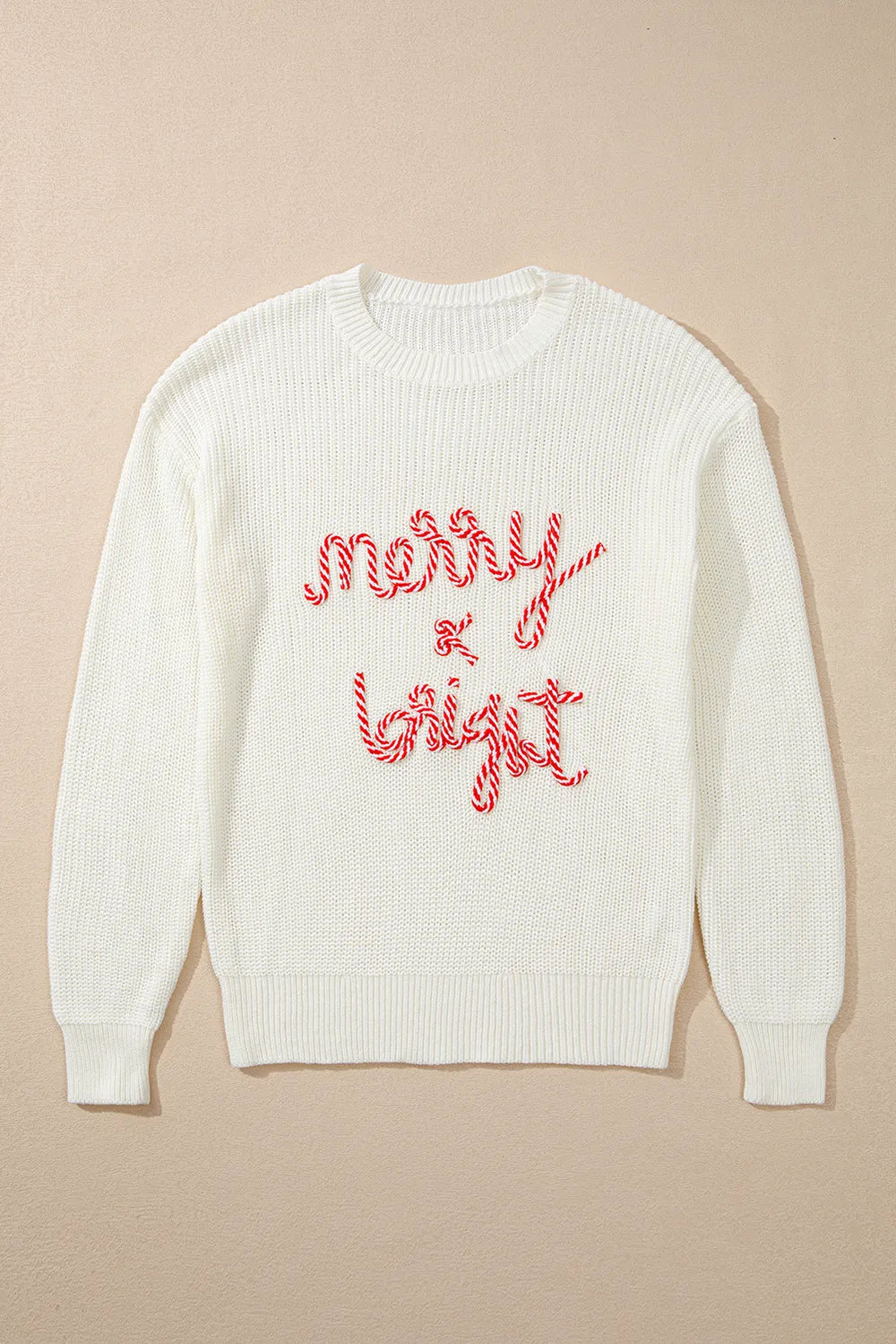 Cream round-neck sweater with red "Merry & Bright" embroidery.