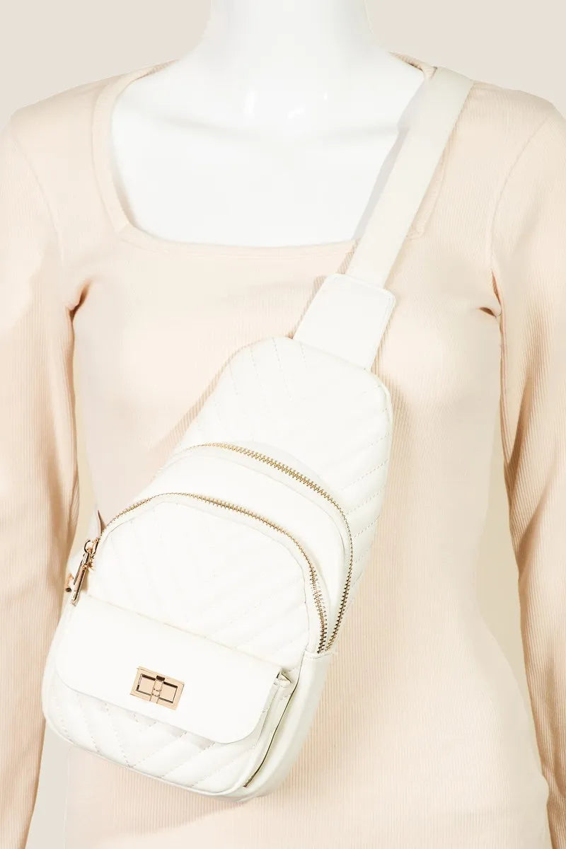 White quilted faux leather sling bag with adjustable strap on mannequin.