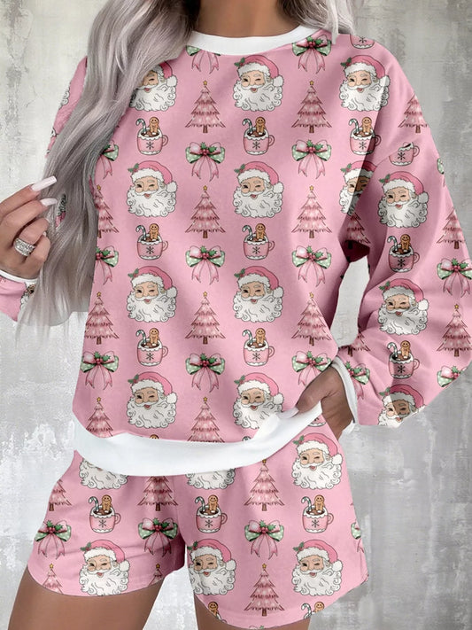 Pink lounge set with festive Santa and Christmas tree print, featuring a long-sleeve top and shorts.