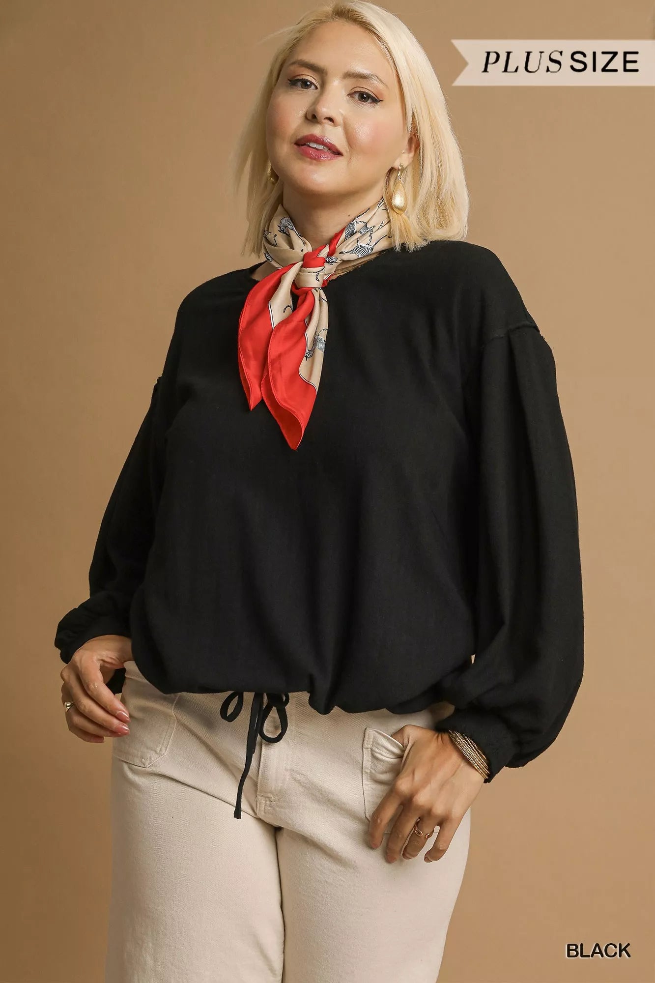 Plus size black linen long sleeve drawstring top on model with red scarf.