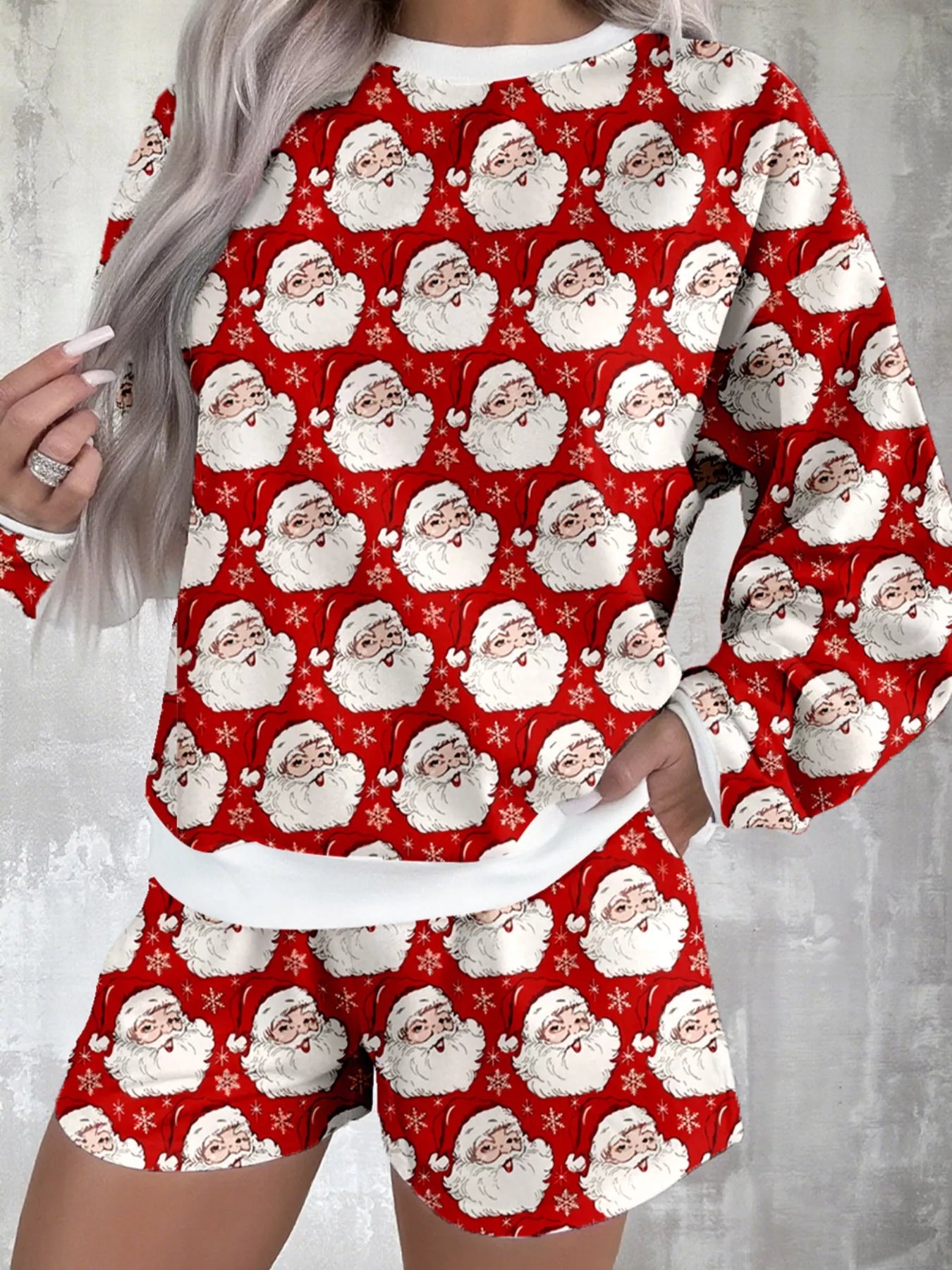 Pink lounge set with festive Santa print, featuring long-sleeve top and shorts.
