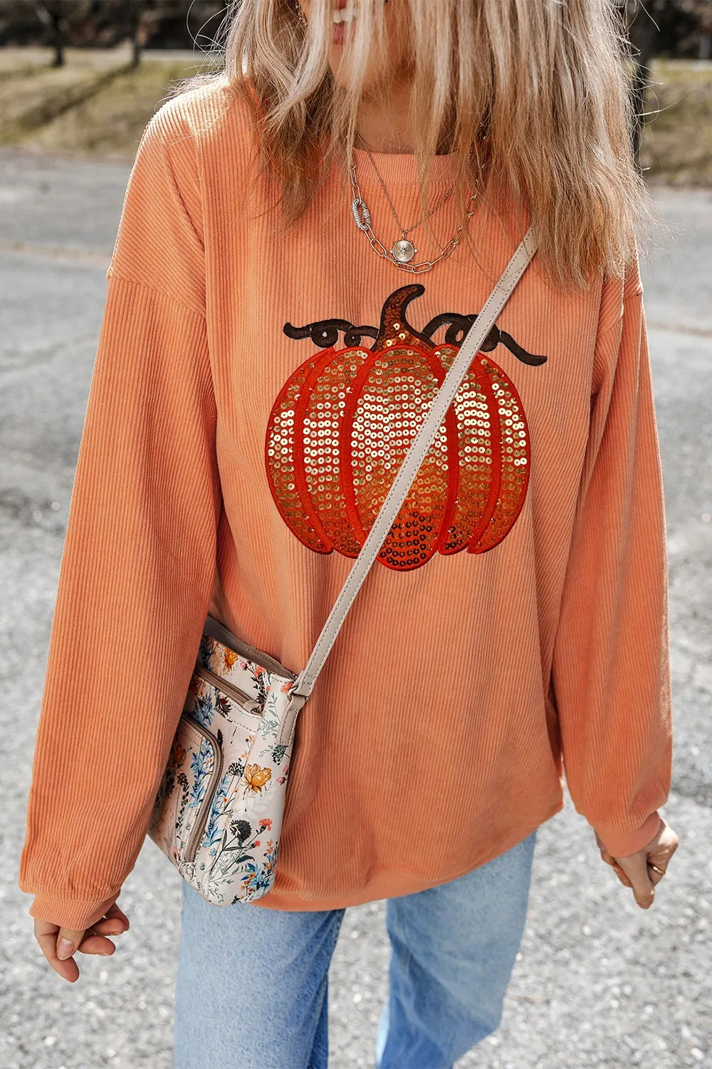 Long sleeve round neck sweatshirt with sequin pumpkin design in cozy polyester fabric