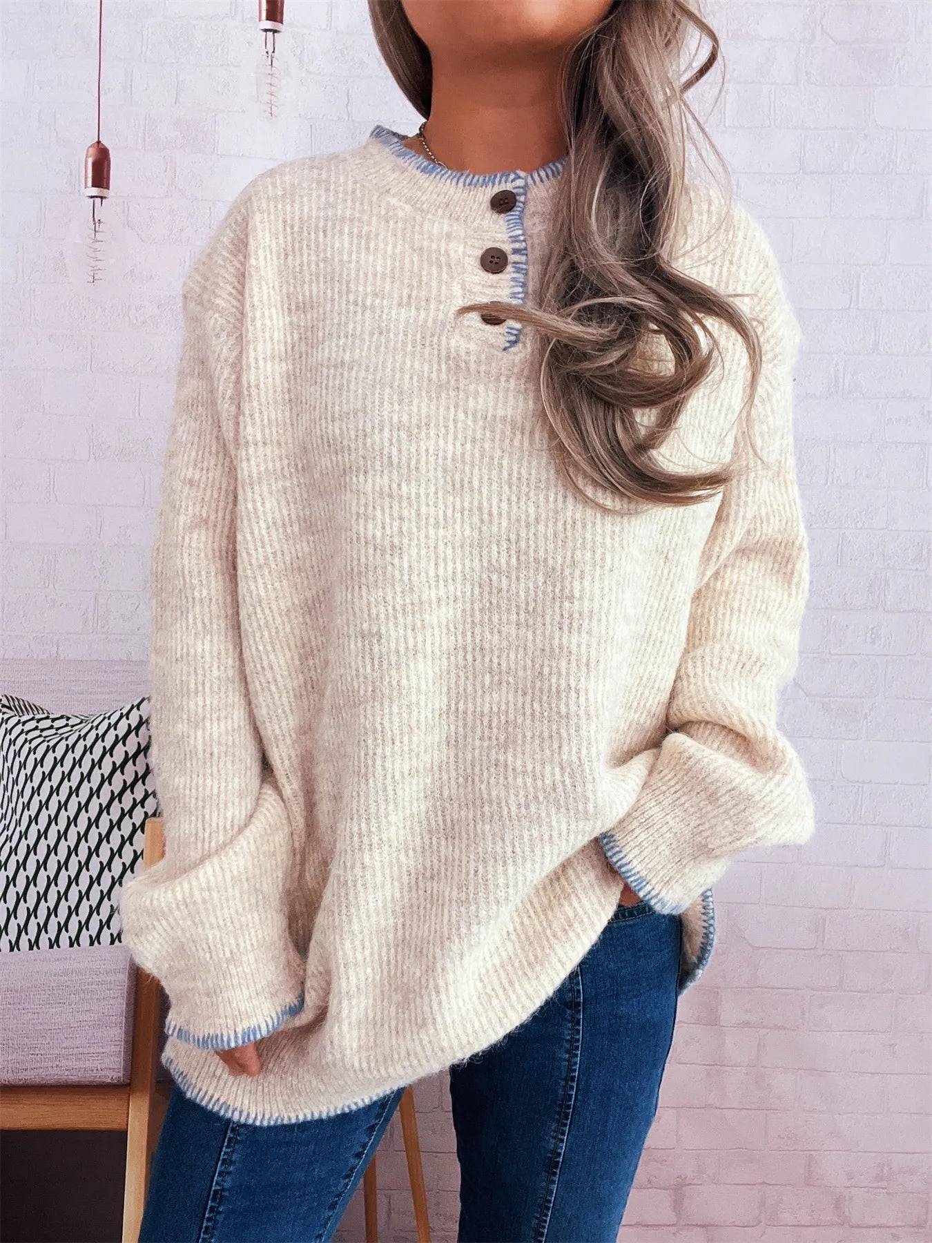 Oversized ribbed long sleeve sweater with button details and contrast stitching in polyester.