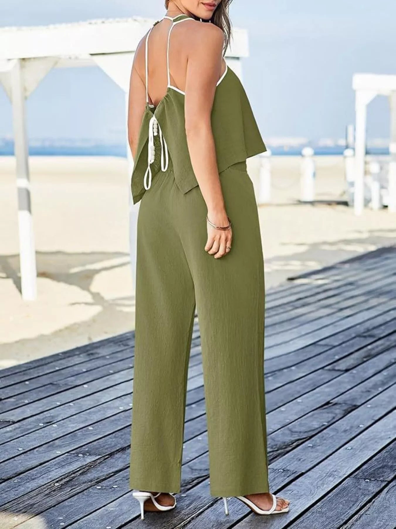 Two-piece tank and pants set with contrast trim, drawstring, and pockets in polyester blend.