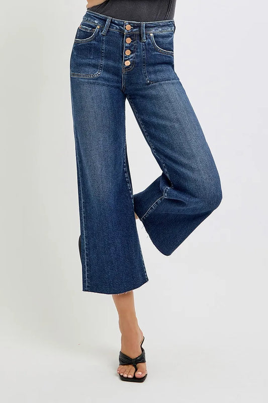 High-rise wide-leg crop jeans in medium wash with button-front and pockets, model posing.