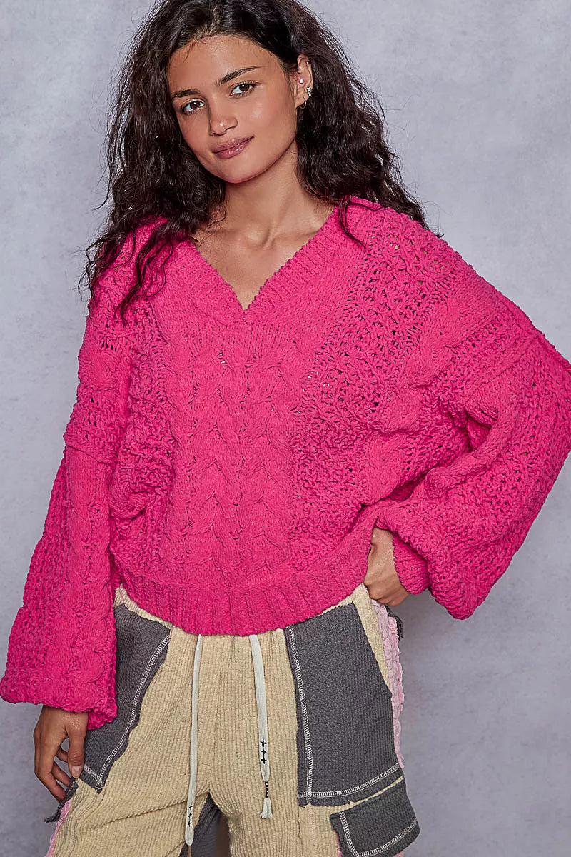 Pink chenille cable-knit V-neck cropped sweater with balloon sleeves on model.