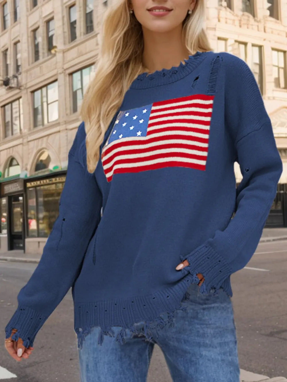 Distressed acrylic sweater with US flag design, round neck, and long sleeves.