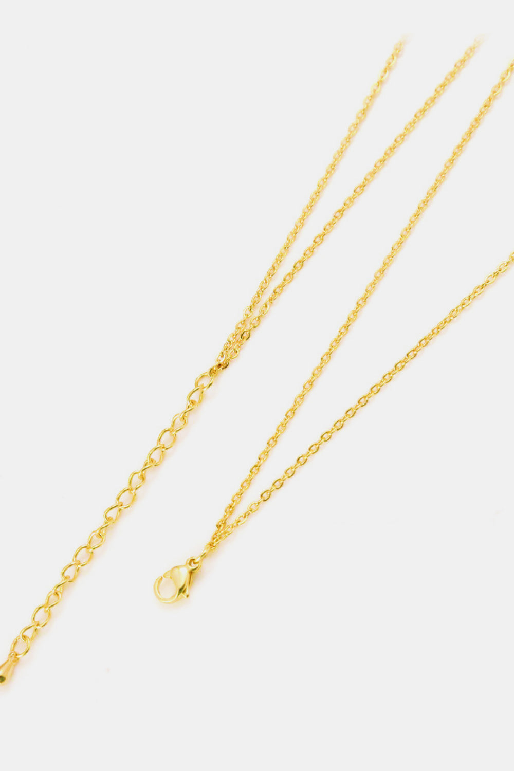 Golden brass necklace with linked ring pendant and chain.