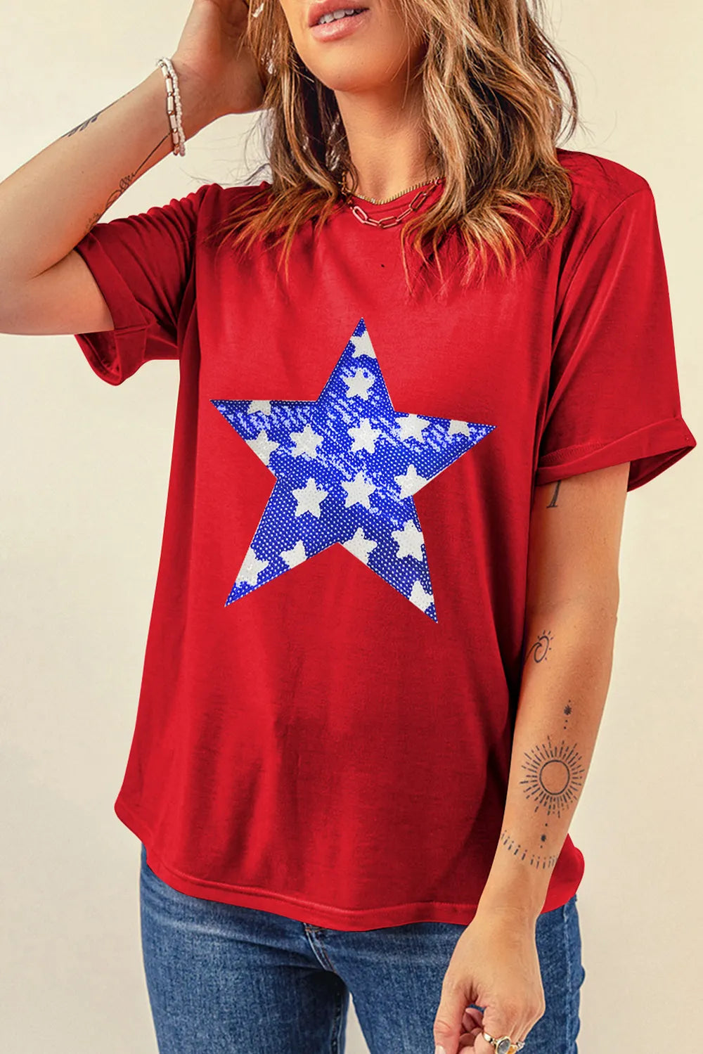 Sheer short sleeve t-shirt with sequin star design and slightly stretchy fabric.