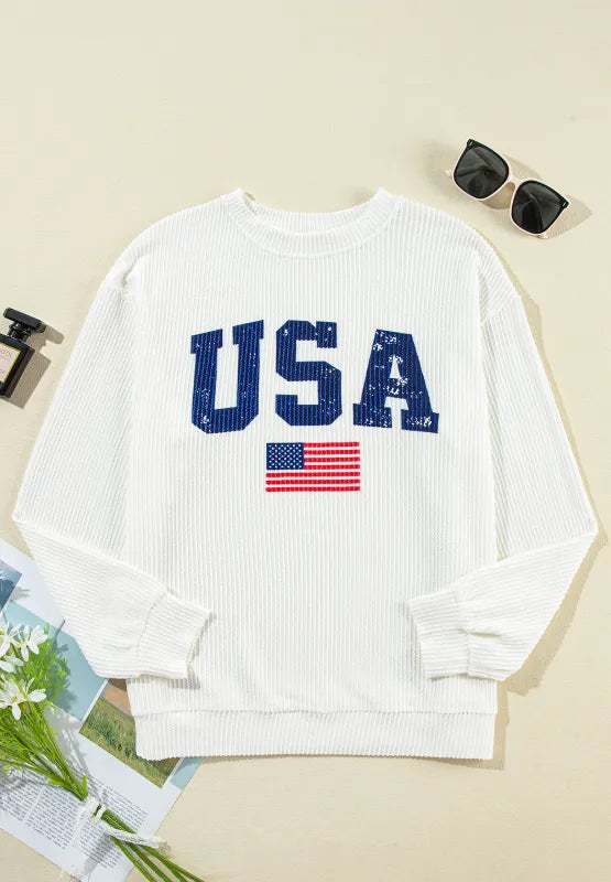 Long sleeve sweatshirt with US flag design in polyester blend fabric and corded texture.