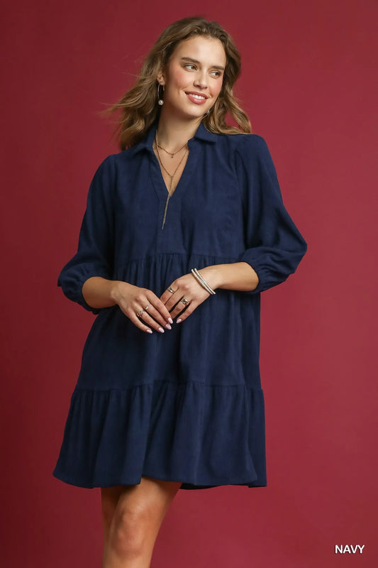 Navy tiered corduroy mini dress with V-neck and balloon sleeves on model.