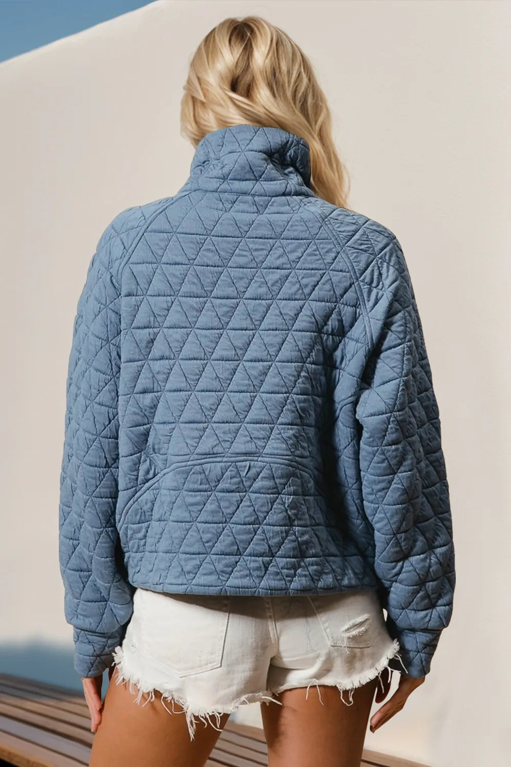 Half-zip quilted sweatshirt in gray with a sheer pocket and long sleeves.