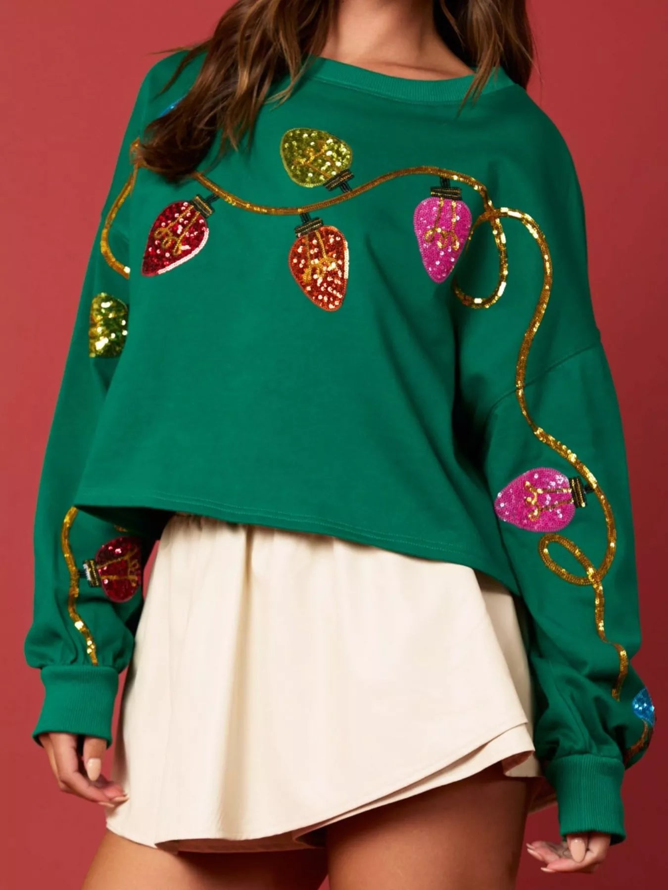 Gray sweatshirt with sequin embellishments, featuring a relaxed fit and long sleeves.
