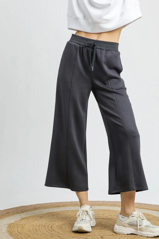 Charcoal gray drawstring wide-leg cropped pants on a model.