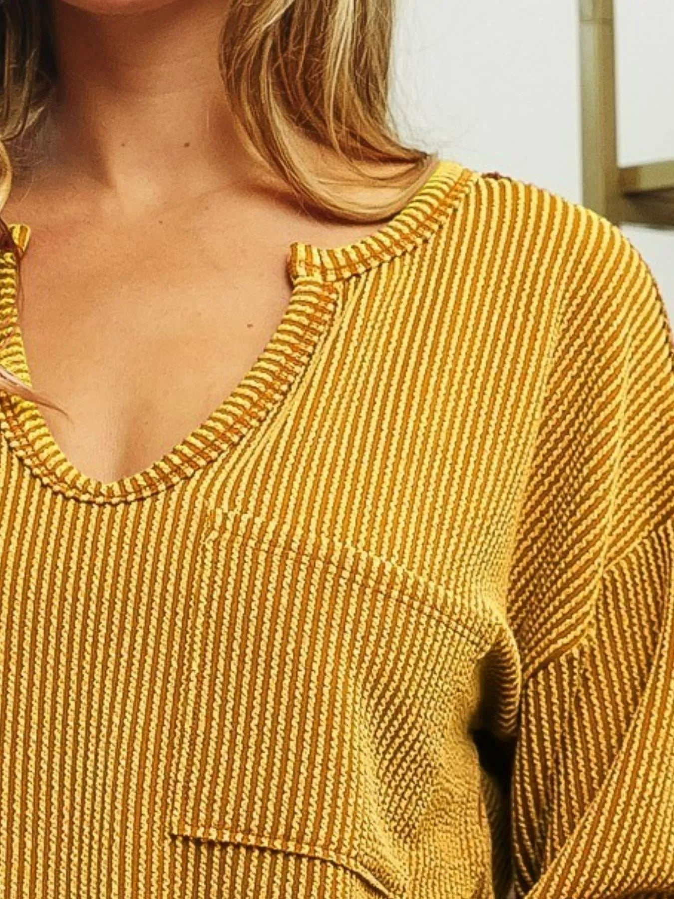 Two-tone ribbed top with notch neck and patch pocket detail in contrasting colors.
