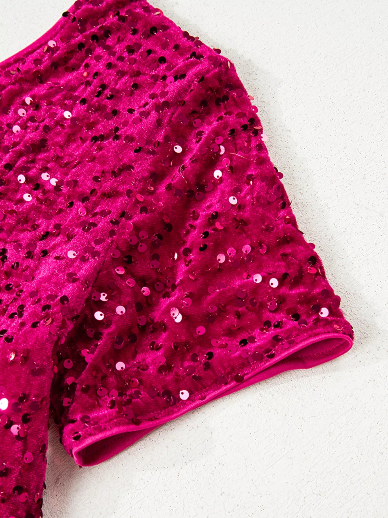 One-shoulder sequin dress in cotton spandex blend with a high slit and elegant silhouette.