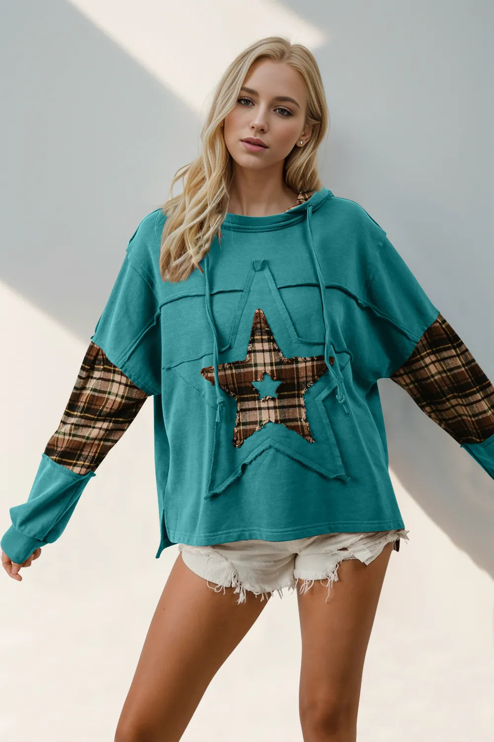 A plaid hoodie with a star patch and drawstring, made from slightly stretchy fabric.