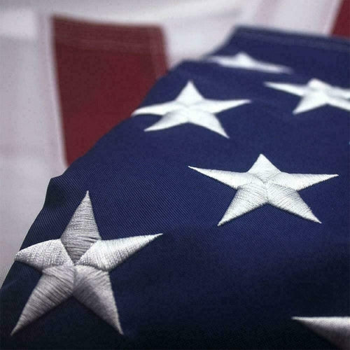 Close-up of embroidered white stars on a heavy-duty nylon USA flag for outdoor use.