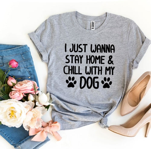 Gray soft cotton graphic t-shirt with "I just wanna stay home & chill with my dog" text and paw prints, styled with jeans and heels.