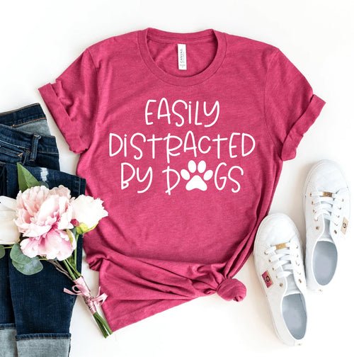 Pink Bella Canvas T-shirt with "Easily Distracted By Dogs" text and paw print.