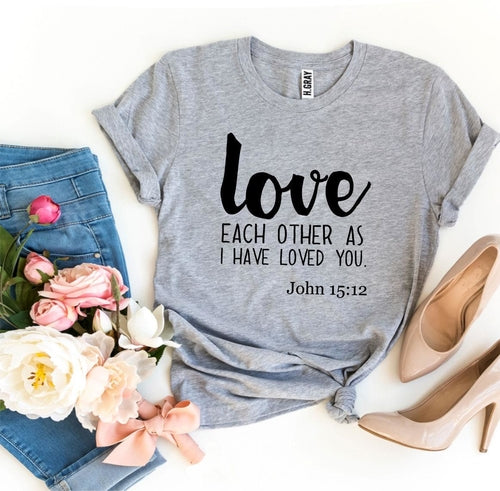 Mauve Bella Canvas T-shirt with "Love Each Other as I Have Loved You - John 15:12" print, styled with jeans and heels.