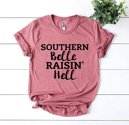 Pink Bella Canvas T-shirt with "Southern Belle Raisin' Hell" text in black.