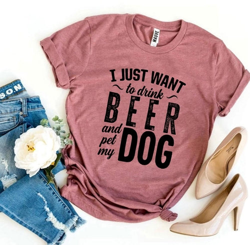 Pink Bella Canvas T-shirt with "I Just Want To Drink Beer & Pet My Dog" text, styled with jeans and heels.
