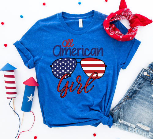 Blue Bella Canvas cotton t-shirt with "All American Girl" text and American flag sunglasses graphic.