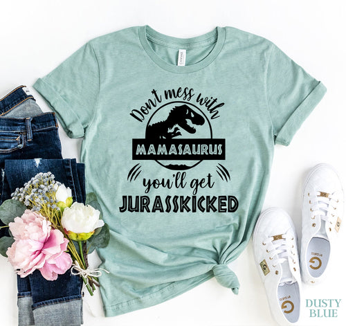 Teal Bella Canvas T-shirt with "Don't Mess With Mamasaurus You'll Get Jurasskicked" dinosaur print, styled with jeans and sneakers.