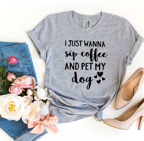 Gray Bella Canvas T-shirt with black text "I Just Wanna Sip Coffee And Pet My Dog" styled with jeans, heels, and flowers.