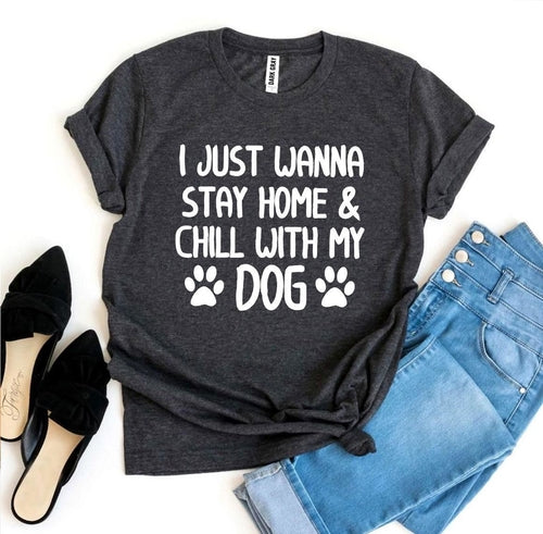 Black graphic t-shirt with "I just wanna stay home & chill with my dog" text and paw prints, styled with jeans and heels.