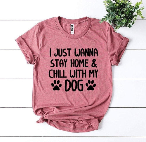 Pink soft cotton graphic t-shirt with "I just wanna stay home & chill with my dog" text and paw prints.