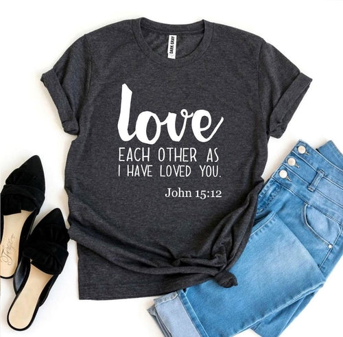 Mauve Bella Canvas T-shirt with "Love Each Other as I Have Loved You - John 15:12" print, paired with jeans and heels.