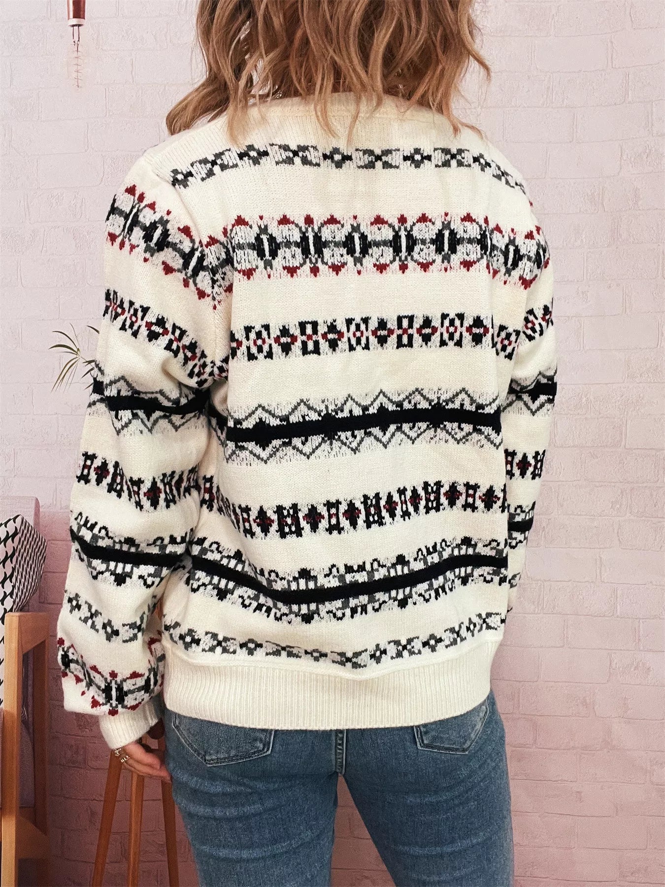 A vintage pattern button-down cardigan made of 100% polyester with slight stretch.