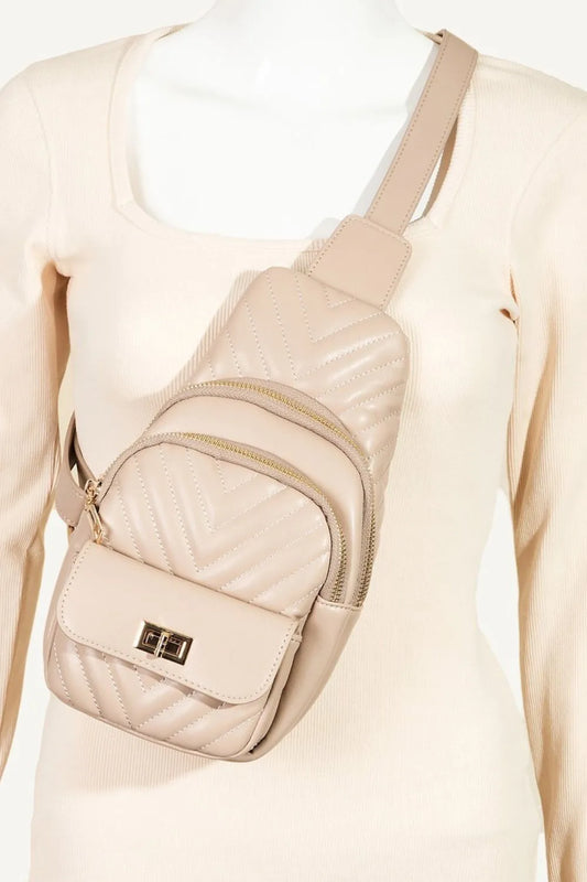 Nude quilted faux leather sling bag with gold hardware on a mannequin.