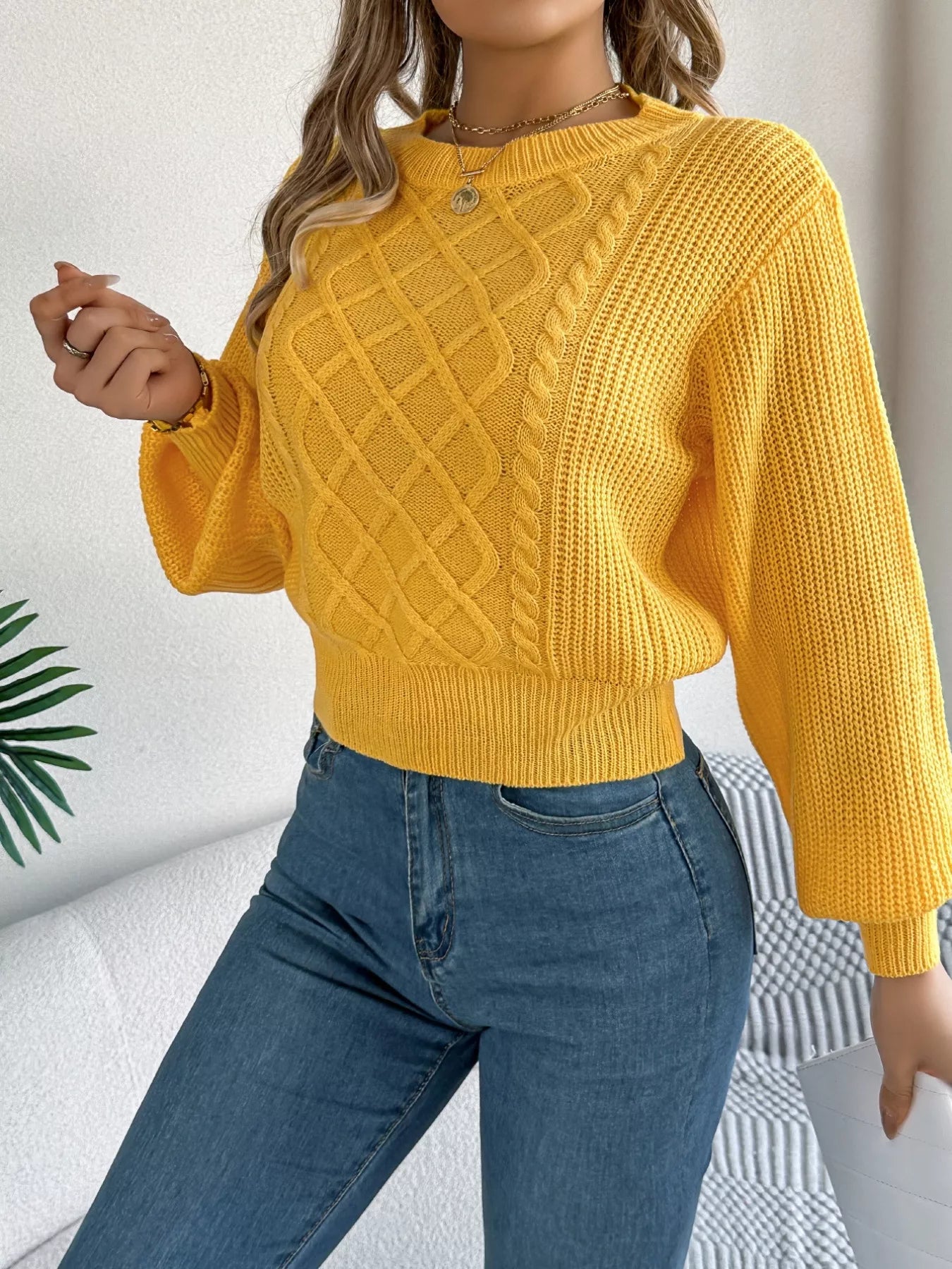 Long sleeve acrylic sweater with cable knit diamond pattern in a cozy fit.