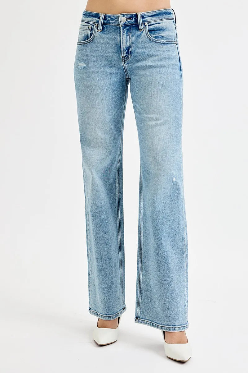 Light wash wide leg flare boyfriend jeans in plus size, shown on model.