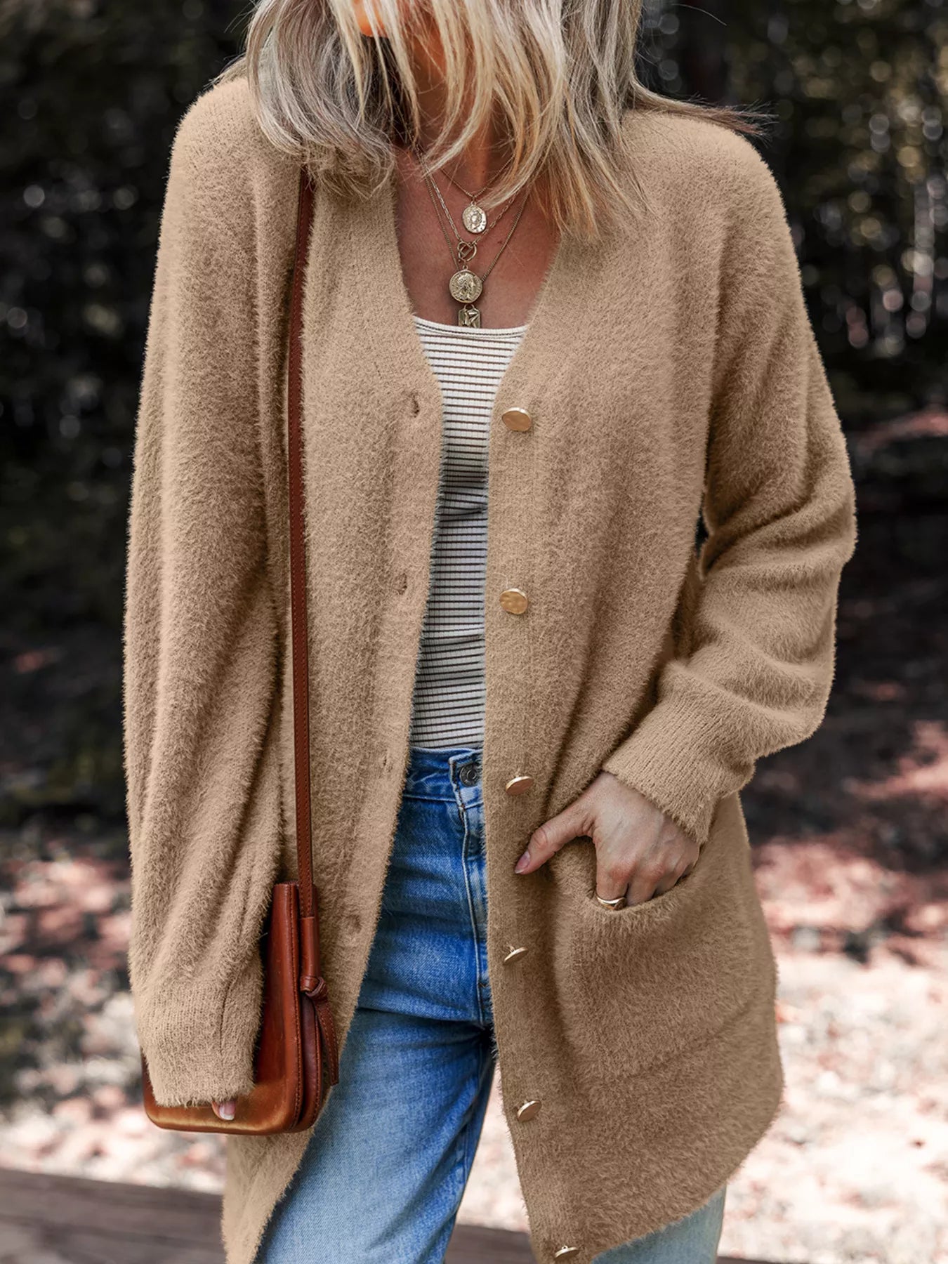 Fuzzy buttoned cardigan in a viscose blend with pockets, ideal for cozy layering.