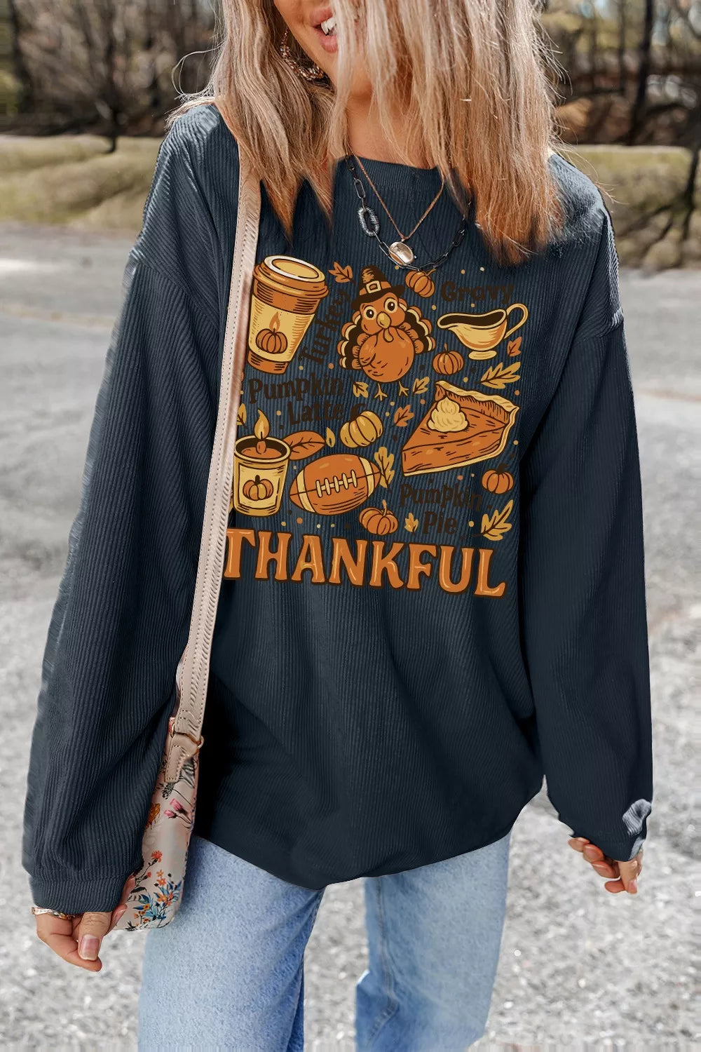 A long sleeve sweatshirt with a Thanksgiving graphic and slightly stretchy polyester fabric.