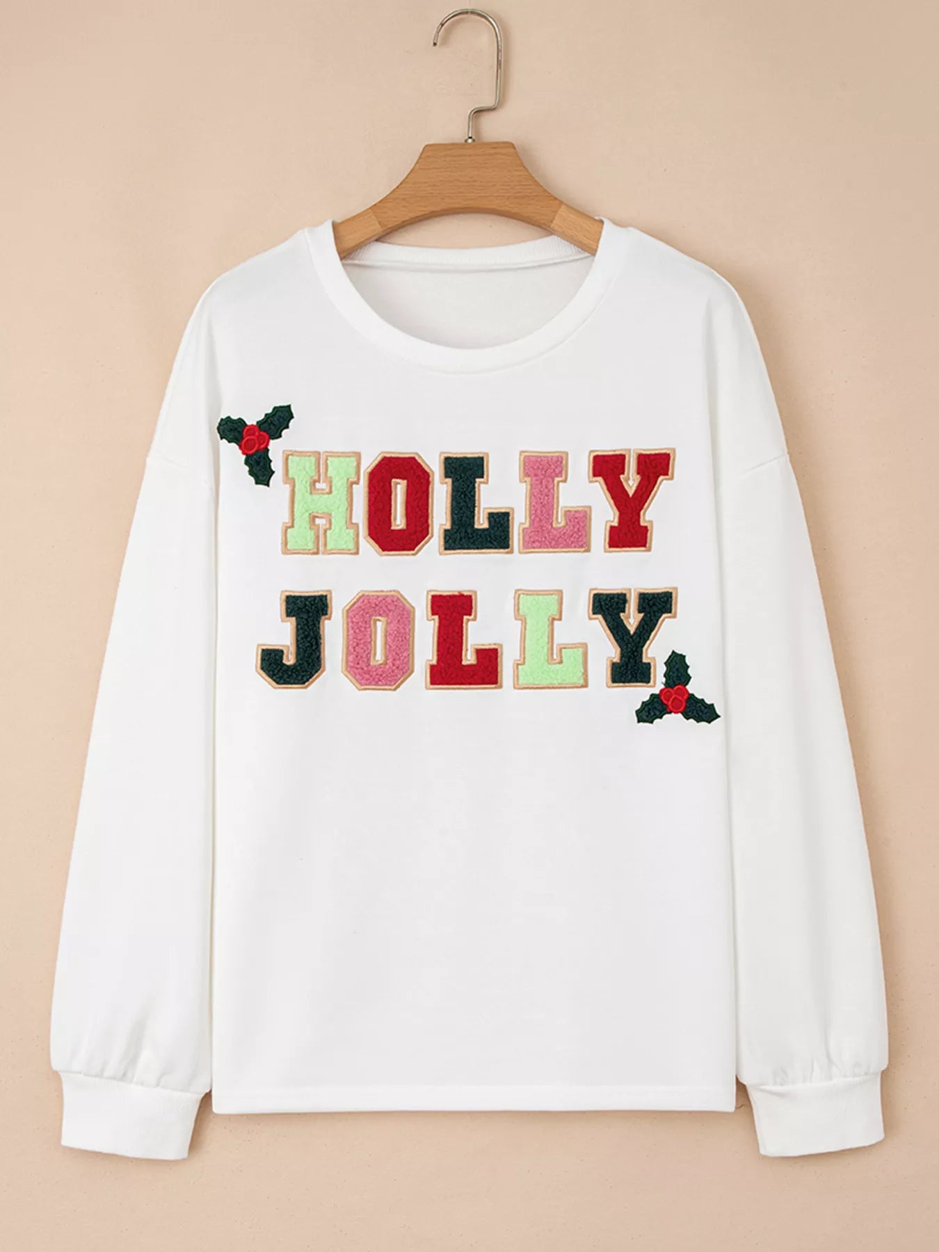 Light gray sweatshirt with embroidered holiday design and round neck in a polyester cotton blend.