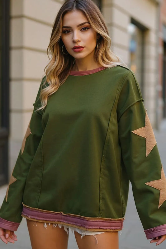 Green long-sleeve sweatshirt with tan star patches on sleeves and pink trim.