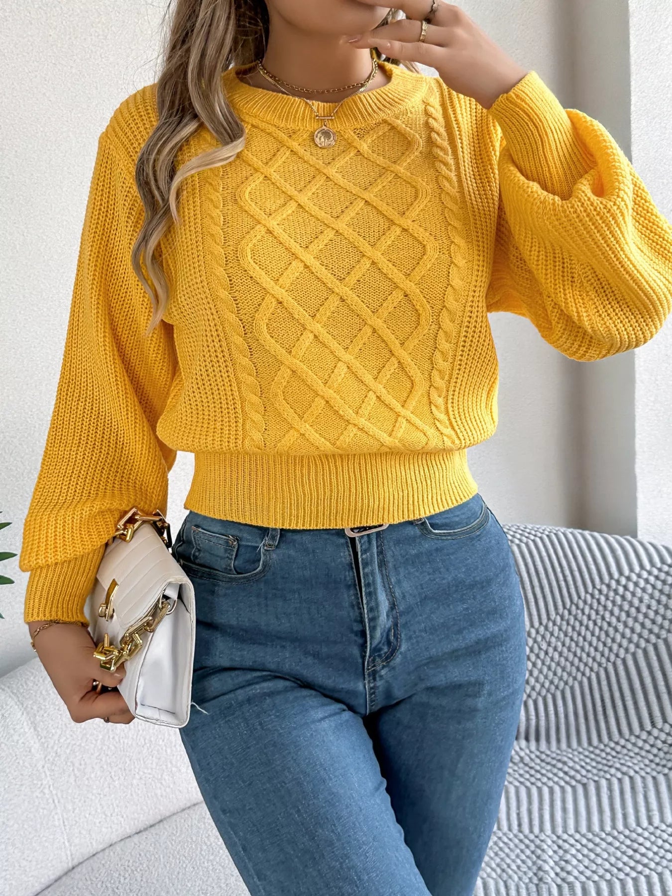 Long sleeve acrylic sweater featuring a cable knit diamond pattern in a cozy fit.