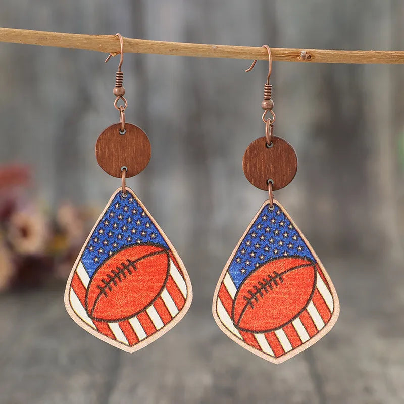 Wooden dangle earrings featuring a printed design with alloy accents, 3.3 inches long.