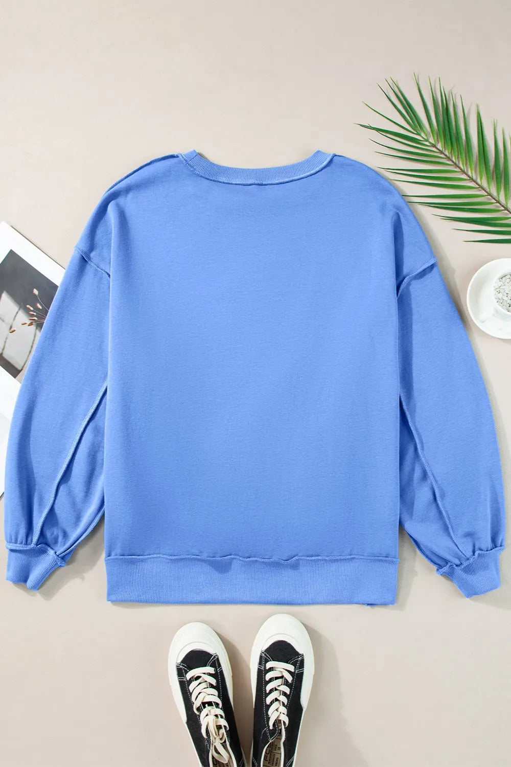 Long sleeve sweatshirt with exposed seams in a cotton-polyester blend.