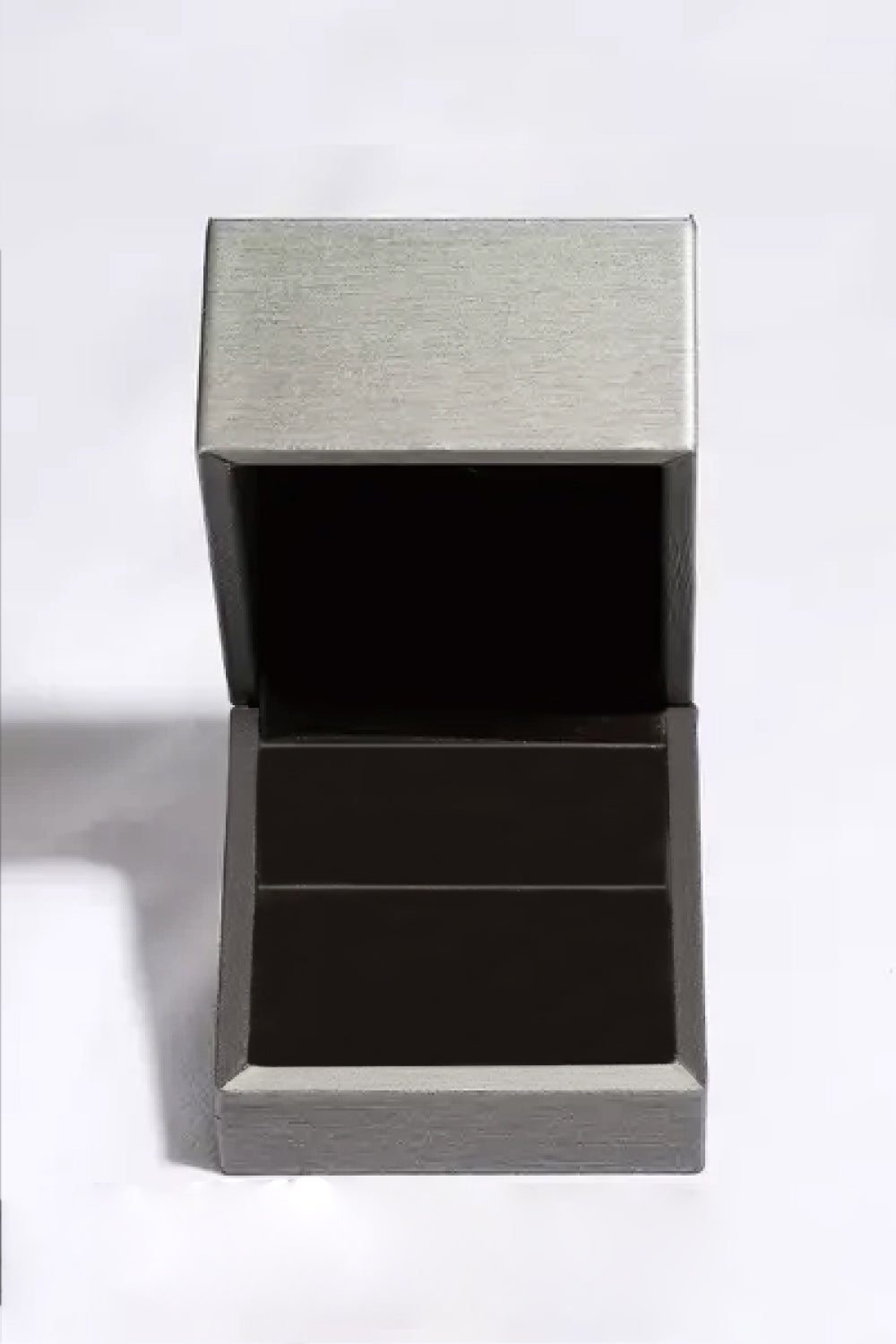 Open silver jewelry box with black interior and two compartments, viewed from above.