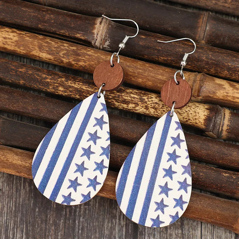 Brown and gold dangle earrings made of PU leather, alloy, and wood blend.