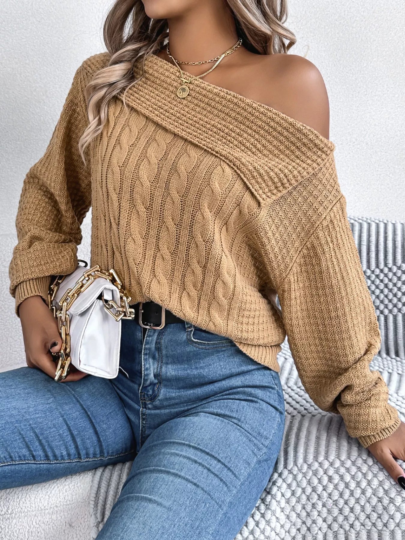 Off-shoulder cable knit sweater in soft, slightly stretchy acrylic with a classic texture.