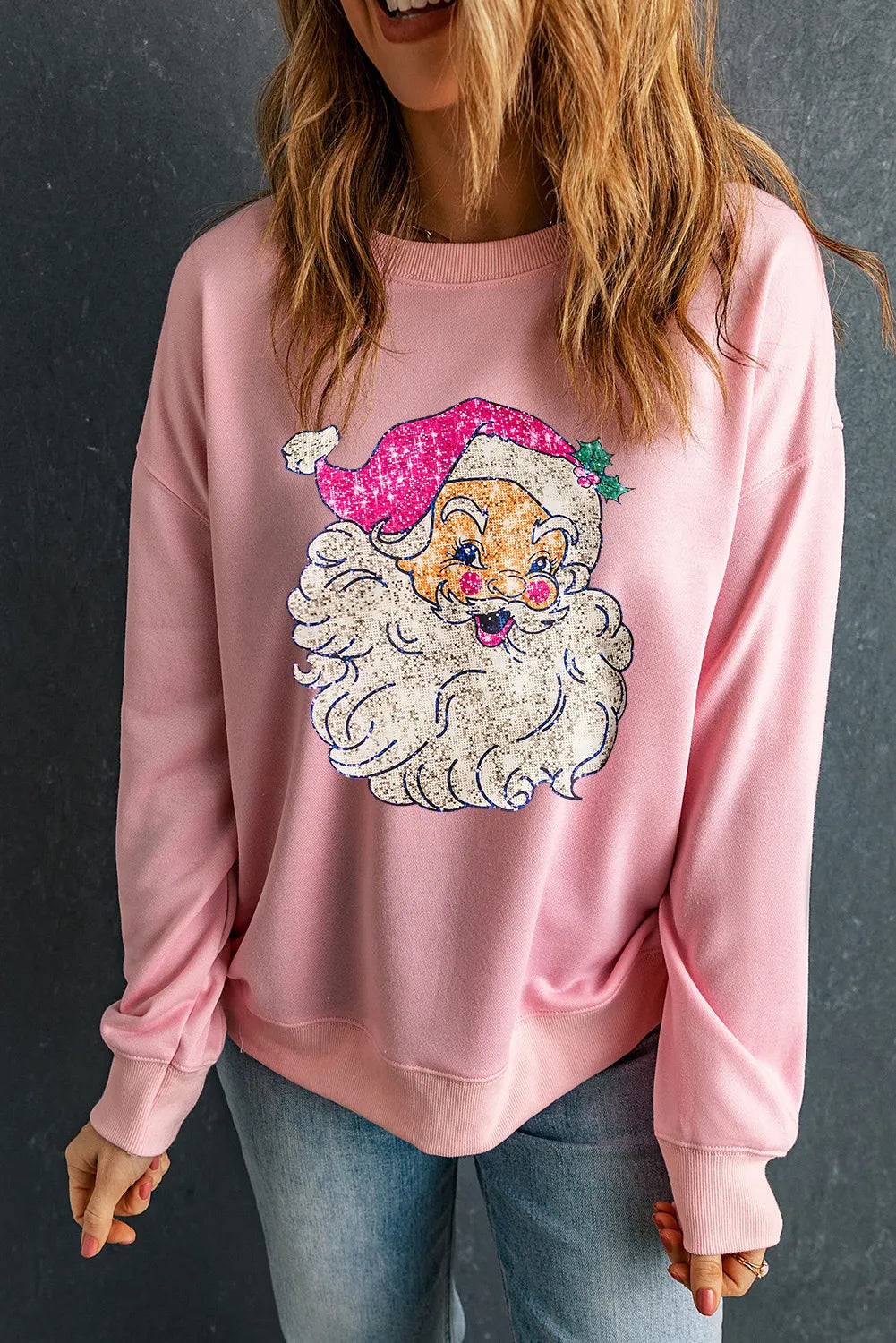 Pink round-neck long-sleeve sweatshirt with embroidered Santa face.
